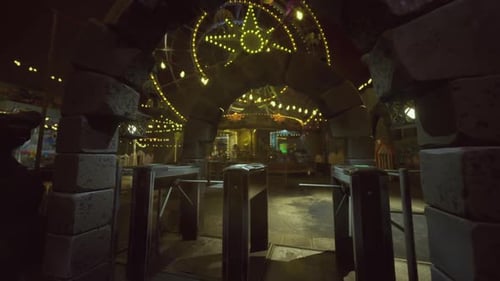 Barren Amusement Area with Flickering Lights and Abandoned Signs at Dusk