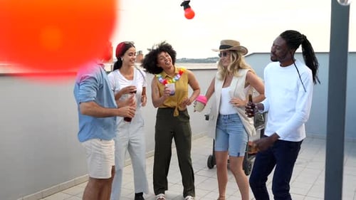 Friends Enjoying a Rooftop Party With Drinks