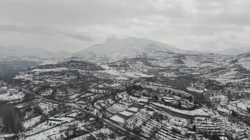 Snow Covered Rural Village – Aerial Drone View of Countryside Homes in Winter