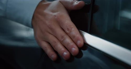 Close up young businessman checking anonymous just repaired in car auto body shop. Slow motion sho