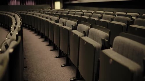 Empty Seats Curving in an Auditorium Highlighting the Concept of Vacancy and Waiting