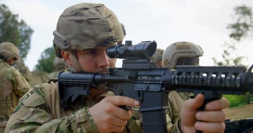 Rear view of Biracial military soldiers rifle training in fields during military training 4k