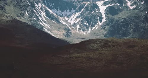 Majestic Mountain Landscape with Snow Capped Peaks Under Blue Sky