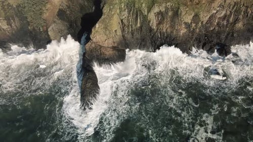 Drone Flying Along Washington Coast With Waves Splashing Rocky Cliffs