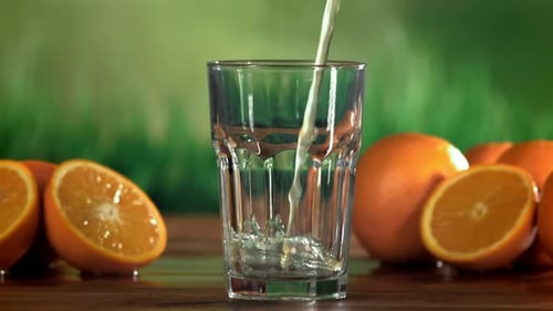 Pouring Fresh Orange Juice into Glass
