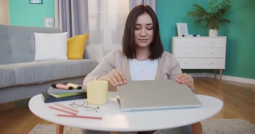 Young Woman Working on Laptop at Home