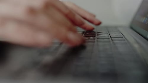 CloseUp of Hands Typing on Laptop Keyboard Working From Home Office