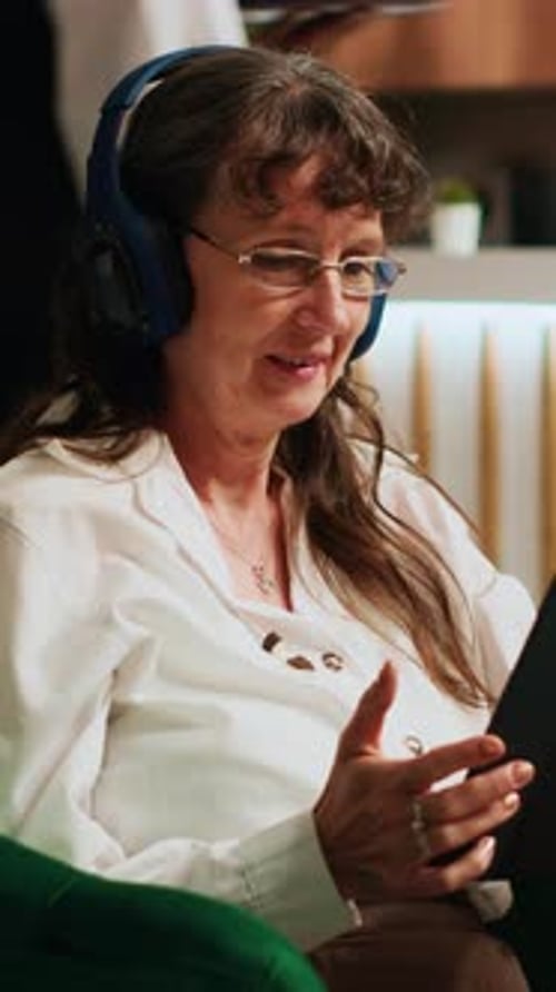 Senior Woman Using Tablet and Wearing Headphones