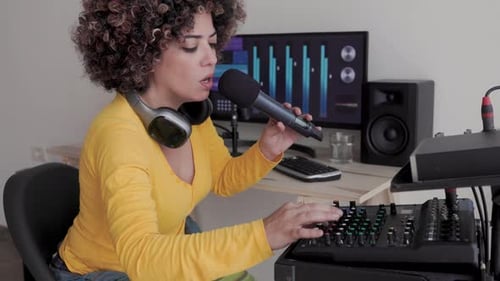 Woman Sings and Adjusts Sound Mixing Board