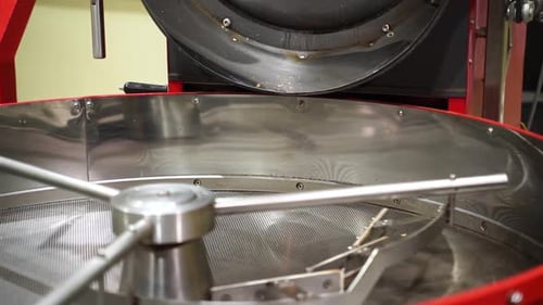 Empty Cooling Tray Of A Coffee Roaster With Cooling Mixers Spinning. close up