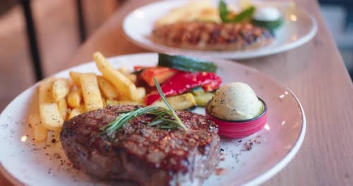 Serving steak with fries and vegetable on a grill