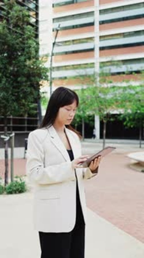 Woman Using Tablet in Urban Business Setting