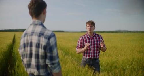 Two Male Farmers Discussing In Field Agriculture Crops Business Talking