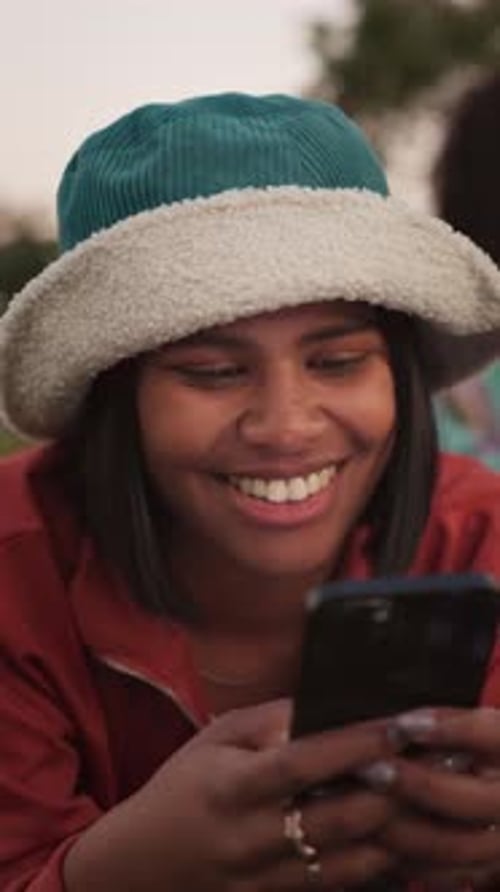 Smiling Woman Using Phone Outdoors