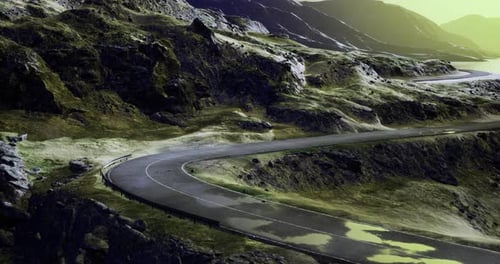 Curvy Mountain Road Winding Through Rocky Landscape During Sunset