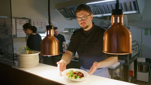 Portrait of Professional Chef Serving Gourmet Dish in Restaurant Kitchen