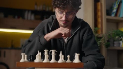 Focused Hispanic Guy Player Playing Chess Mind Game at Home Hipster Look Chessboard Thinking