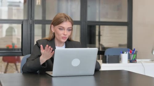Young Woman Working on Laptop During Video Call