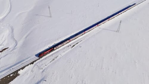 A train is traveling through a snowy field Dogu Ekspresi