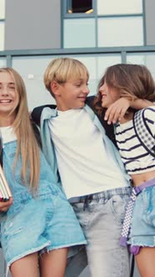 Portrait Happy Smiling Group of High School Kids Hugging Looking at Camera Children Two Girls and