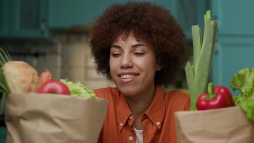 Smiling African American Woman with Grocery Bags