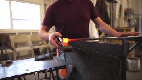 Glass Blower Rolling and Shaping Glass on Rod in Workshop 3034 Years
