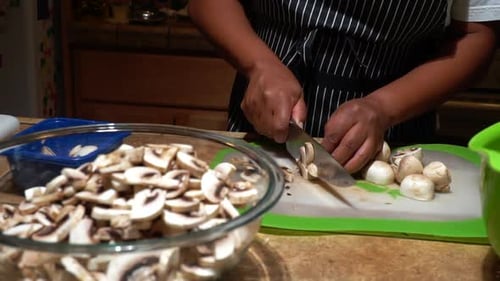 Adult Chopping Mushrooms in Kitchen