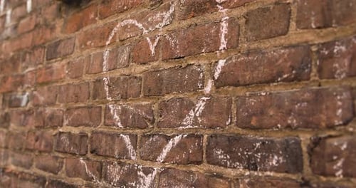 Heart Drawn in Chalk on Brick Wall - Handheld Close