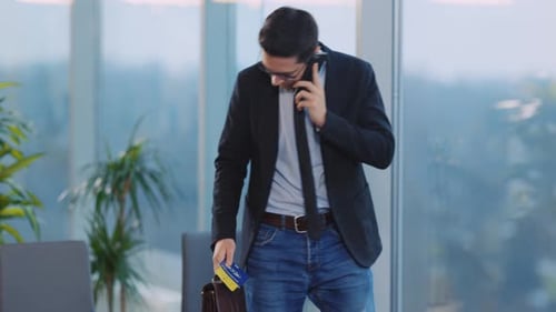 Man Talking on Phone, Sitting with Briefcase