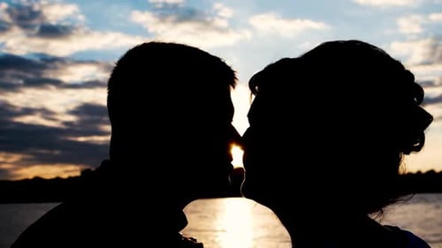 Honeymoon in the Sea Bay Silhouette of a Loving Couple Kissing at Sunset Enjoying Vacation