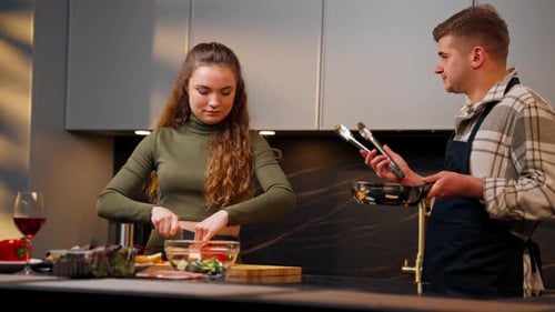 Couple Prepares Meal Together in Modern Kitchen