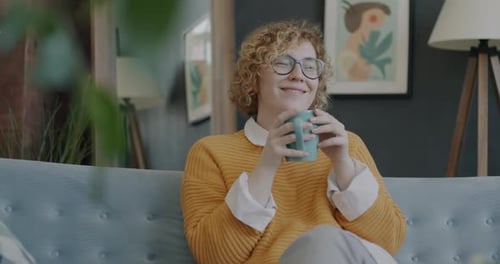 Young Woman Relaxing at Home With Mug