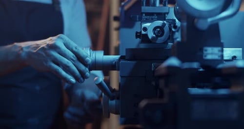 Crop Craftsman Operating Metal Lathe in Garage