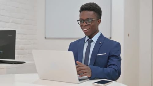 Young Adult Celebrates Success at the Office