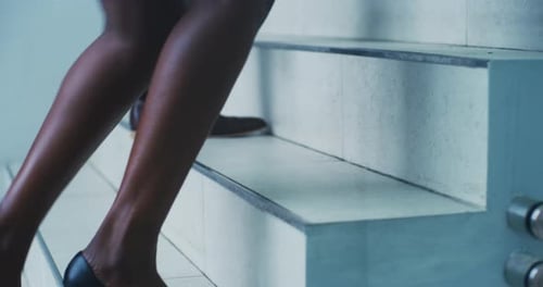 4k video footage of two unrecognizable businesswomen walking up stairs on their way to work