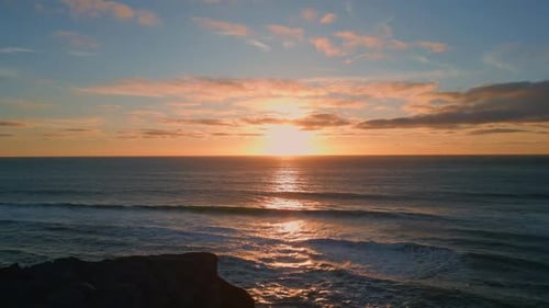 Perfect Golden Sunset Over the Ocean Horizon with Rolling Waves