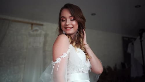 Elegant Woman Poses in White Dress Indoors