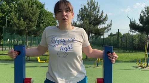 Young woman works out at the sport area outdoors