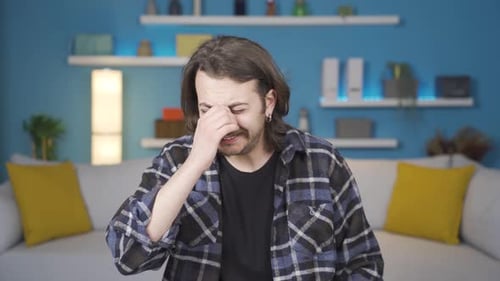 Unhappy man crying looking at camera. Gestures.