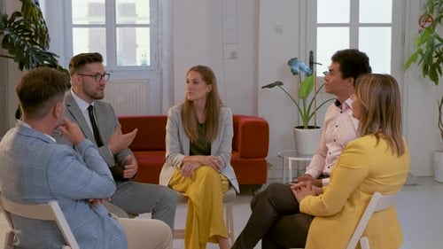 Group of business people having a meeting while sitting in circle in office.
