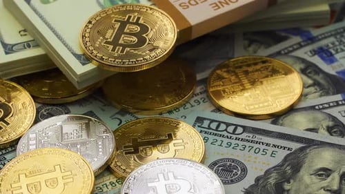 Gold and Silver Bitcoin Coins on Dollar Bills