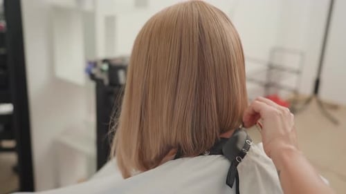 Woman with Blonde Hair Getting a Haircut at Salon