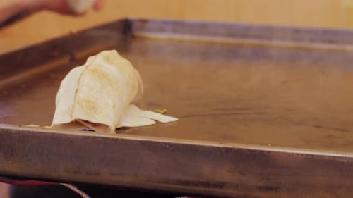 Preparing Shawarma Wraps on a Hot Griddle