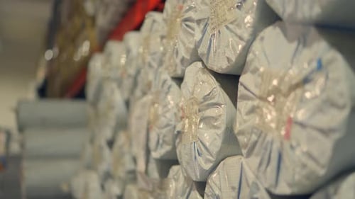 Packed Fabric Rolls Stacked In Tent Making Factory Sialkot Pakistan Textile Manufacturing Warehouse