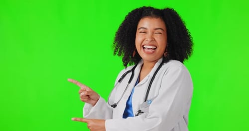 Happy woman, doctor and pointing on green screen for healthcare advertising against a studio