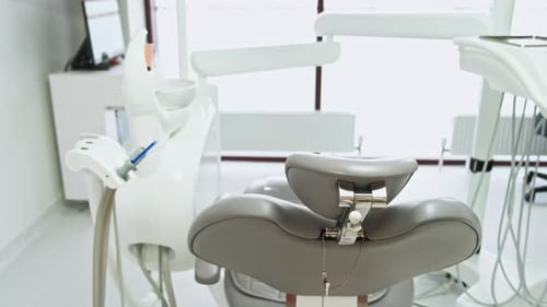 A Modern Dental Office Featuring a Comfortable Chair and Advanced Equipment for Patients