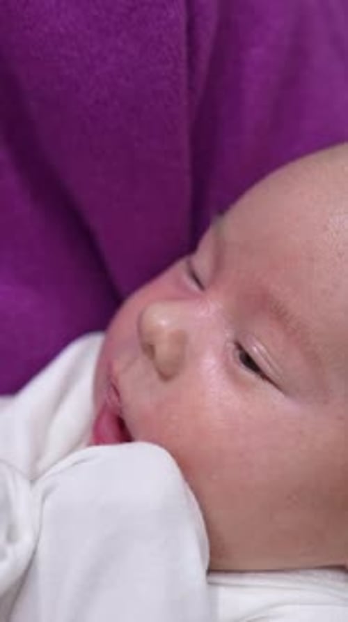 Close Up on Baby Feeding from Bottle