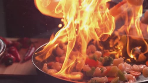 Shrimp and vegetables flambe cooking food preparation