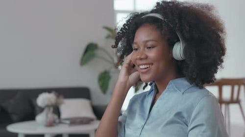 Woman Listens to Music and Sings at Home