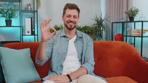 Young Adult Man Gives "Okay" Hand Gesture